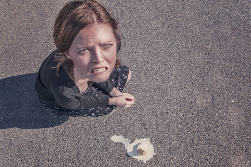A women with a dropped ice cream cone indicating a sense of failure